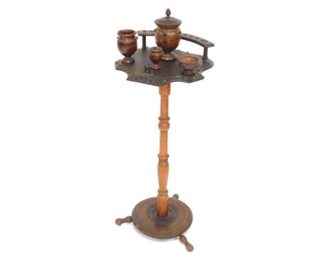 A walnut smoker's stand, with applied star finials, and a rack and jar stand, on a turned column on tripod base. (AF)