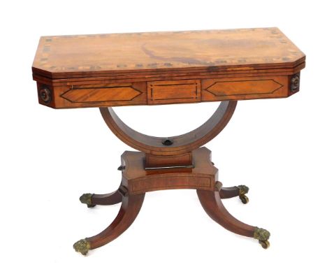 A 19thC Regency mahogany and coromandel card table, with canted corners and fold over top, with green leather inset, on shape