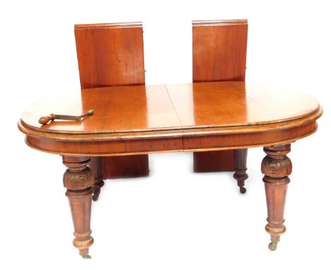 A 19thC mahogany extending dining table, with rounded ends on heavy baluster legs terminating in ceramic castors, 75cm high, 