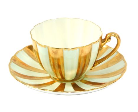 A Shelley cup and saucer, on a light green and gilt flared design. (AF)