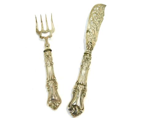 A set of Victorian silver fish servers, comprising knife and fork, with heavy foliate scroll loaded handles, bearing the init