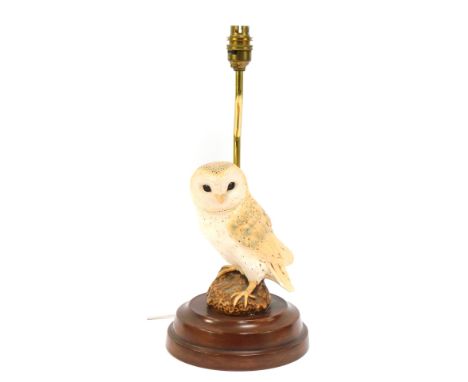 A 20thC pottery owl table lamp, with brass mount and floral shade, 37cm high. (AF)