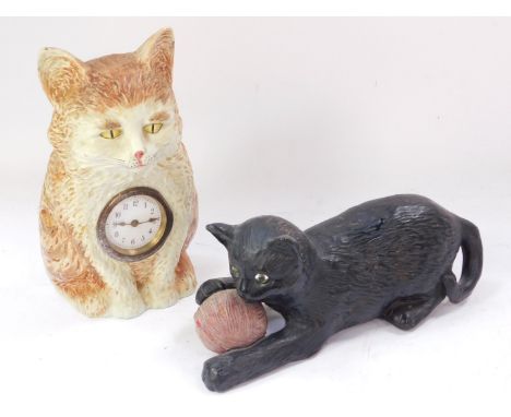 A late 19thC/early 20thC Bretby black painted terracotta model of a cat, with a ball of string, impressed mark down the side,