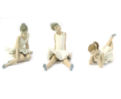 Three Nao pottery figures of seated ballerinas, marked beneath, 14cm high. (3)