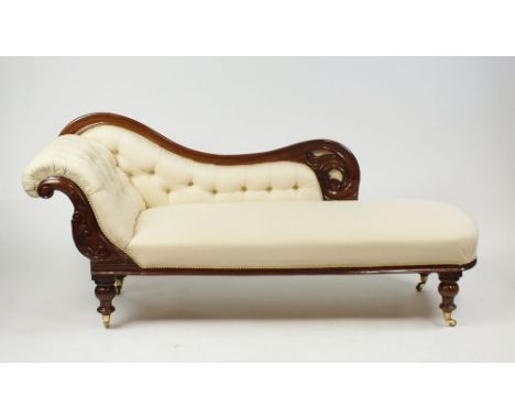 A Victorian mahogany chaise longue, later upholstered in cream button down fabric with undulating scroll back and foliate car