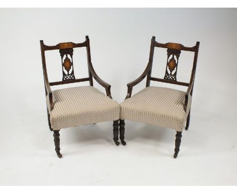 A pair of Edwardian mahogany and boxwood strung nursing or music chairs, each with a fleur de lys inlaid pierced lozenge spla