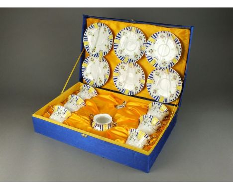 A Limoges porcelain tea service in original case, comprising six teacups, six saucers, sucrier and cover, each decorated in b