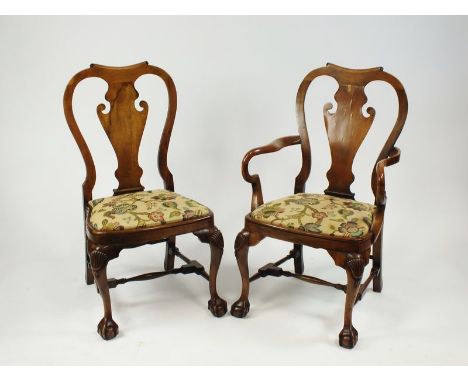 A set of eight (6+2) Queen Anne style walnut dining chairs, each with shaped vase splat and crewel work style tapestry seat r