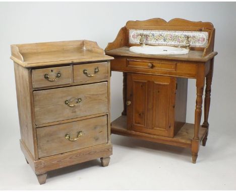 An Edwardian pine washstand with later ceramic liner and taps, with a cupboard below raised on pilaster and block legs, 91cm 