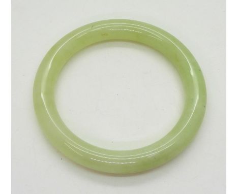 A Chinese green hardstone bangle, inner diameter 6.5cm Condition Report:Available upon request