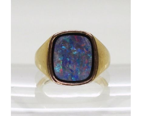 A 9ct gold gents signet ring set with an opal doublet on onyx, finger size R, weight 9gms Condition Report:Available upon req