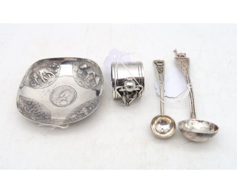 A Peruvian white metal napkin ring, decorated with a llama, a white metal ladle and scoop, the finials with filigree work and