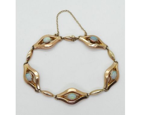A rose gold opal bracelet, set throughout in 9ct, with five 6mm x 4mm lively opals. Length 18cm, weight 7.6gms Condition Repo
