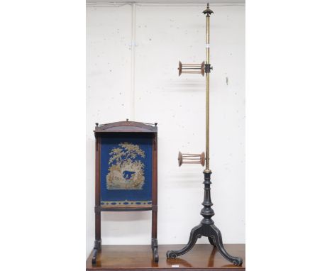 A Victorian brass wool winder on ebonised tripod base, 54cm high and a tapestry fire screen (2) Condition Report:Available up