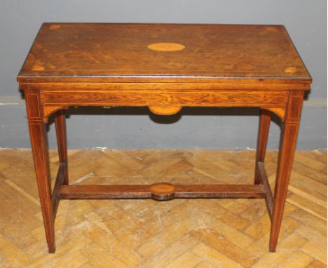 A 19th century Rosewood, boxwood inlaid and strung card table, the folding swivel top raised on square tapering legs, united 