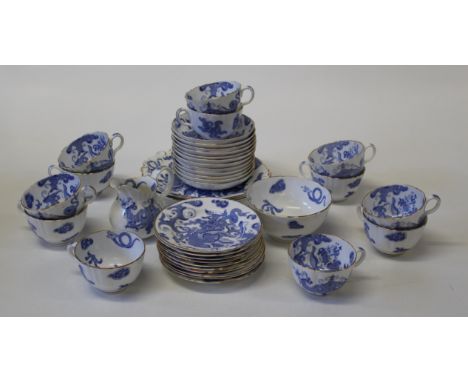 An early 20th century Royal Worcester blue dragon decorated tea service, comprising two cake plates, twelve tea cups and sauc