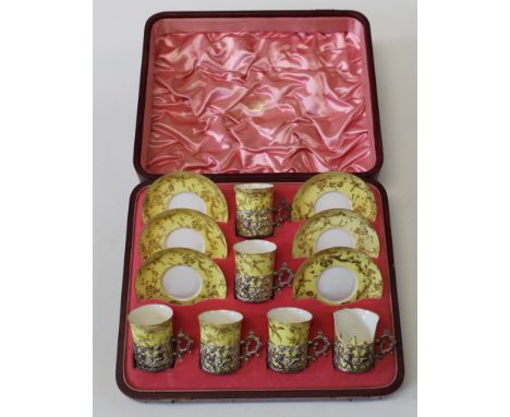 A cased set of six Copeland China coffee cans and saucers, the cans with silver cages by Mappin and Webb, Sheffield 1897