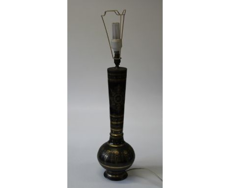 A late 20th century Middle Eastern design brass onion form table lamp with fringed shade. 57cm high (excluding fittings)