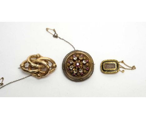Three antique brooches, including a black enamel mourning brooch, with plaited hair plaque; and one set pink and white stones
