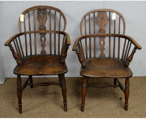 Two 19th Century ash and oak Windsor armchairs, with pierced spats and spindle backs, solid seats on turned legs with stretch