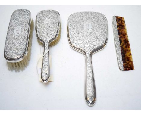 A silver backed four piece dressing table set, comprising hand mirror, clothes brush, hair brush and comb, marked ‘Goring Ste