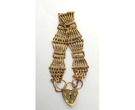 A 9ct yellow gold gate link bracelet with heart shaped clasp, 28.5g. 