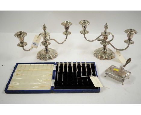A cased set of eight silver handled knives, by Atkin Brothers, Sheffield; together with a pair of silver plated twin branch c