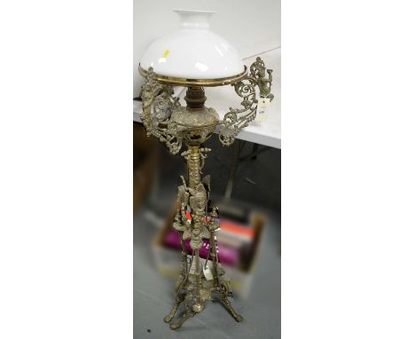 A Victorian brass standard lamp, with opaque glass shade, later wired for electricity. 