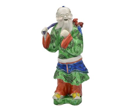 A CHINESE ‘FAMILLE-ROSE’ PORCELAIN FIGURE OF SHOU LAO, QING DYNASTY, QIANLONG PERIOD, 1736 – 1795Modelled standing, the beard