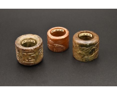 A GROUP OF THREE CHINESE CARVED JADE ARCHERS THUMB RINGS, QING DYNASTYThe stones of brownish tone, the first carved with two 