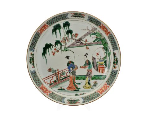 A LARGE CHINESE ‘FAMILLE-VERTE’ PORCELAIN DISH, QING DYNASTY, KANGXI PERIOD, 1662 – 1722Painted with two ladies on a garden t