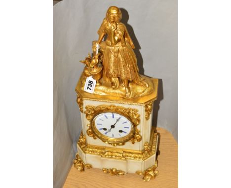 A MID 19TH CENTURY FRENCH GILT METAL AND WHITE MARBLE MANTEL CLOCK BY RAINGO FRERES OF PARIS, the surmount cast as a woman wi