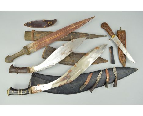 A SMALL ACCUMULATION OF ASIAN/MIDDLE EASTERN/ARABIC SHORT SWORDS AND DAGGERS, a short sword, straight blade (rusted) containe