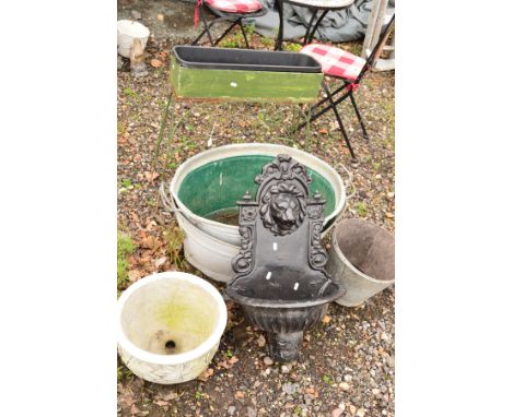 A METAL PLANTER ON A STAND, two galvanised bath tubs and a bucket, a painted metal water feature with spout to lions mouth, l