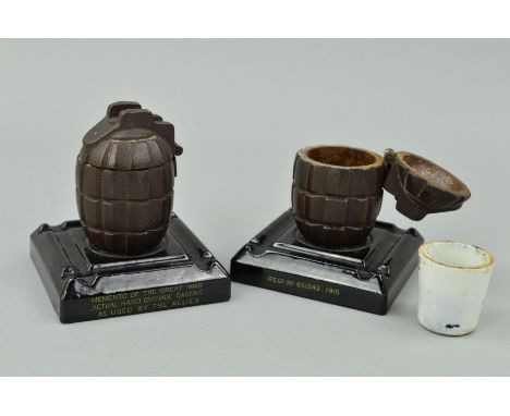 TWO WWII ERA BRITISH HAND GRENADE CASTINGS FASHIONED INTO ASHTRAYS/INKWELLS, mounted on a plinth, the plinth states 'Memento 