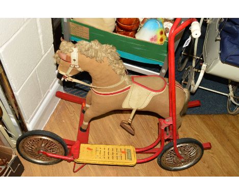 A WOODEN ROCKING HORSE, plush covered, fabric mane and tail, painted wooden mouth and hooves, plastic eyes (one missing, leat