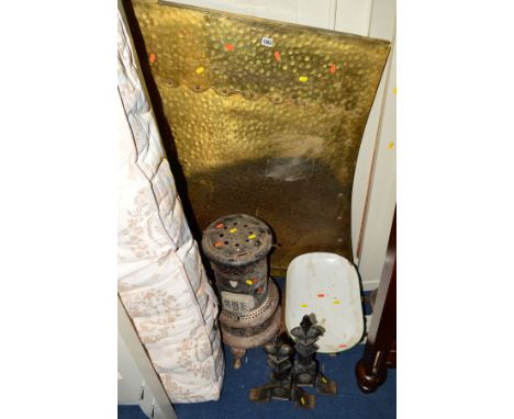 A PAIR OF CAST IRON FIRE DOGS AND LIGHT, a large brass fire hood, a metal paraffin heater and a set of scales (5)