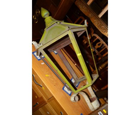 AN EARLY 20TH CENTURY PAINTED WROUGHT IRON PILLOR TOP LANTERN (no glass panels)