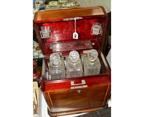 AN EDWARDIAN COMBINED TANTALUS AND GAMES COMPENDIUM TYPE INLAID BOX, fitted with three glass decanters and two glasses, a cri