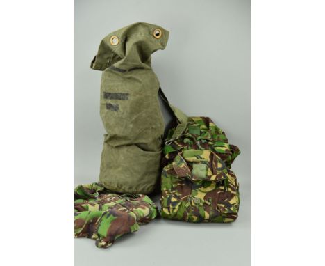 A GREEN CANVAS ARMY ISSUE BAG, containing four pairs of camo trousers, combat NATO DPM and four combat smock jackets NATO DPM