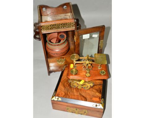 A SMALL OAK SMOKERS CABINET, with glazed door, with tobacco jar and a pipe, height 32cm, together with a set of postal scales