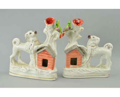 A PAIR OF VICTORIAN STAFFORDSHIRE POTTERY SPILL VASES, modelled as a pair of Spaniels with front legs resting on the roof of 