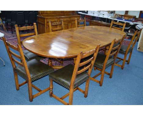 A REPRODUCTION TUDOR OAK OVAL TOPPED EXTENDING DINING TABLE on a cross stretchered base, with additional leaves, approximate 