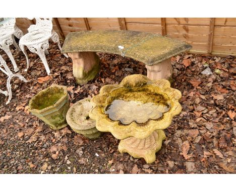 A COMPOSITE CURVED BENCH, together with a oyster shaped bird bath, an octagonal composite planter and a small urn (4)