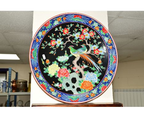 A JAPANESE CERAMIC CHARGER, the central panel decorated with a pair of exotic birds perched in a tree, the rim decorated with