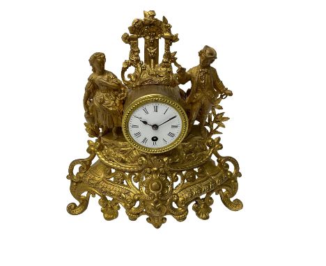 French - late 19th century French  8-day spelter mantle clock, with rococo decoration and a drum timepiece movement flanked b