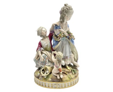 19th century Meissen figure group Broken Eggs, modelled as a pair of female figures, one with a garland of flowers and a putt