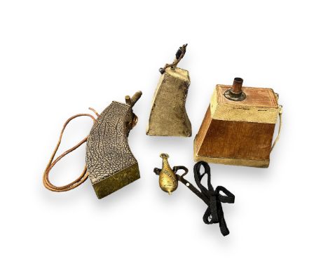 Four Powder Flasks. One small brass flask with strap. One flask with brass plates and brass tip, with strap. One wooden flask