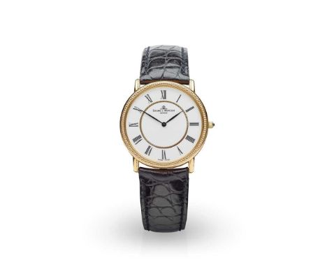 model number 15607, quartz movement, round white dial with Roman numerals in black, inner gold circle to centre of dial, bead