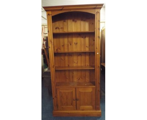 A Pine Three Shelf Open Bookcase with Cupboard Base. 